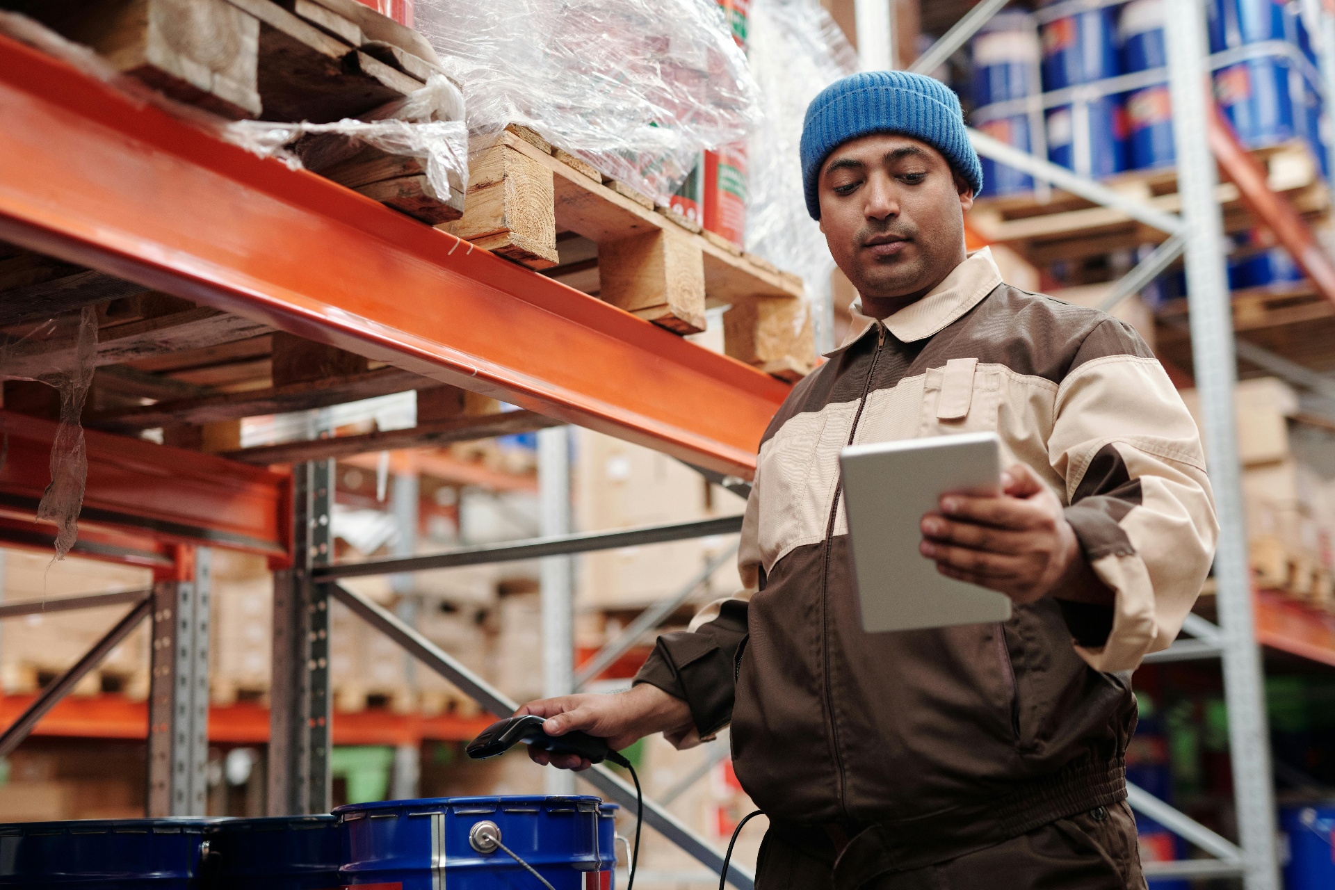 Retail associate scanning shelf inventory in a modern convenience store